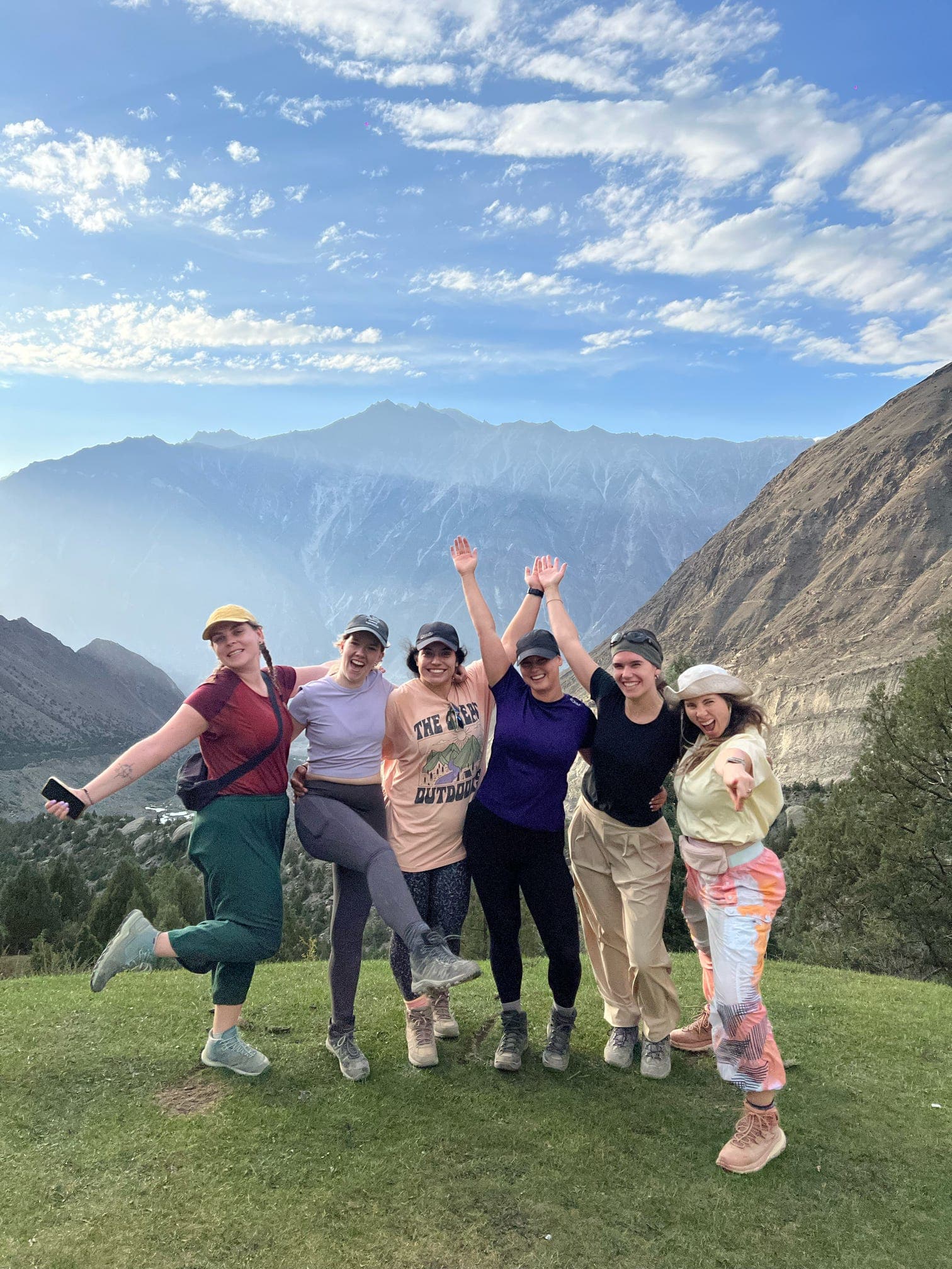 Ready For Road travelers celebrating together in a mountain valley