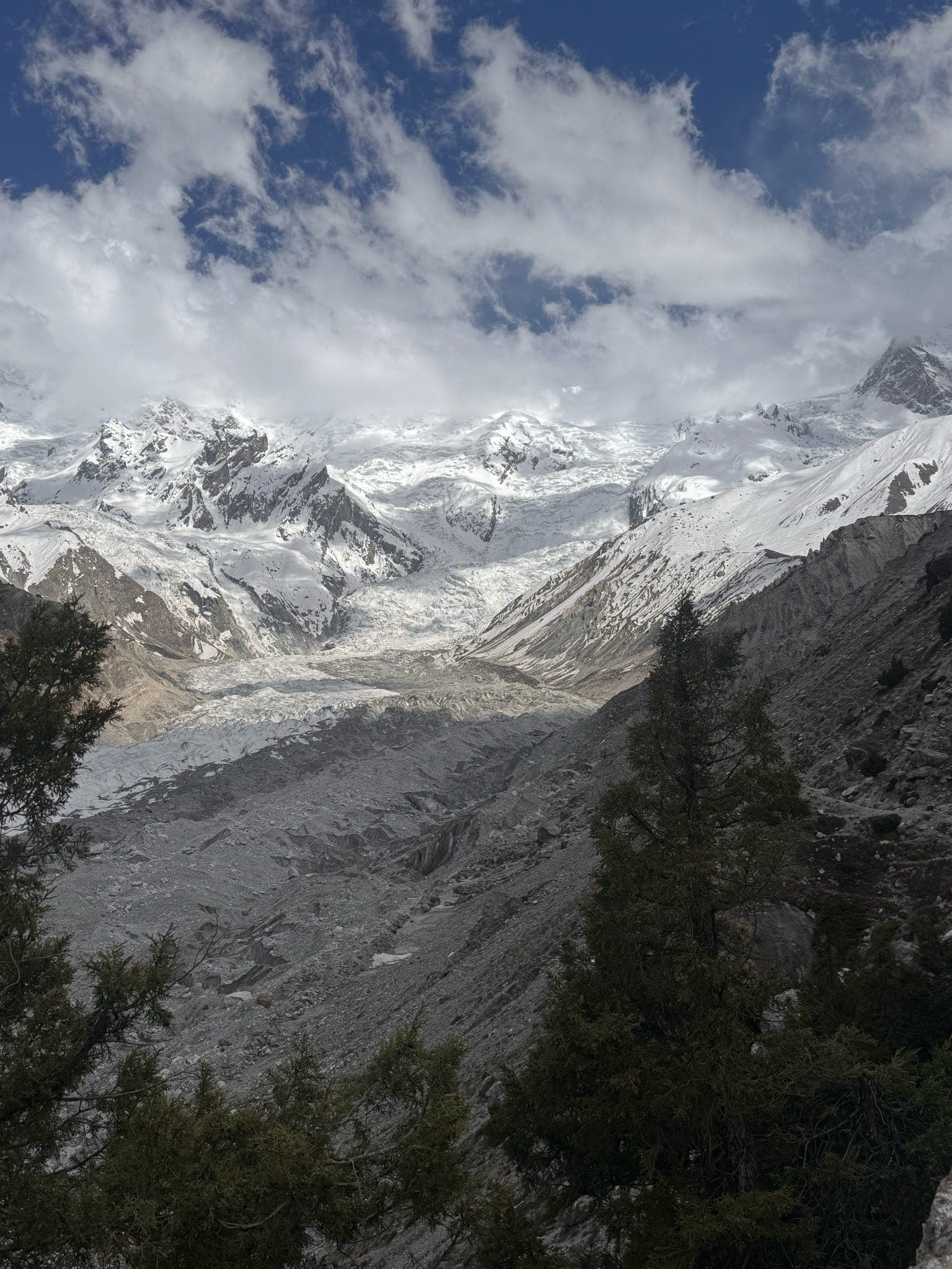 A glacier winding through a high mountain valley