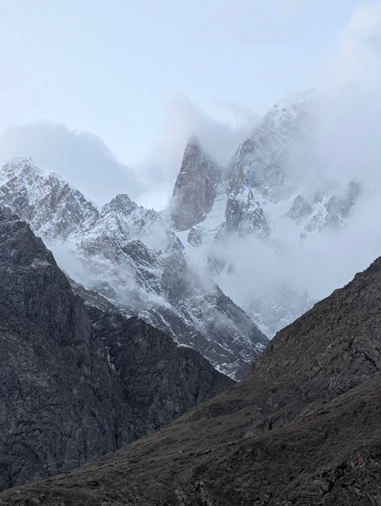 Snowy mountain spires beneath dramatic clouds